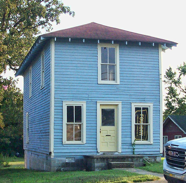 Narrow two-story house with blue paint