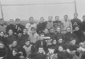 Group of young white men gathered on football field