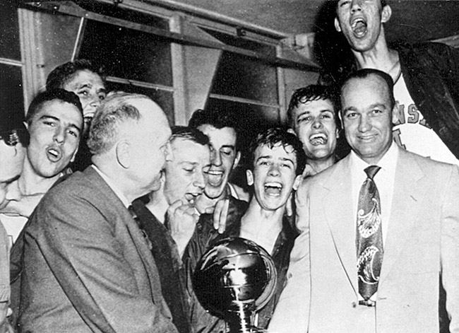 White men with trophy and young men behind them cheering