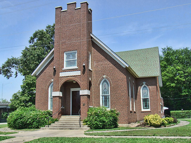 Single-story brick church building with central tower section
