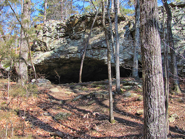 Close-up of cave entrance with rock outcropping