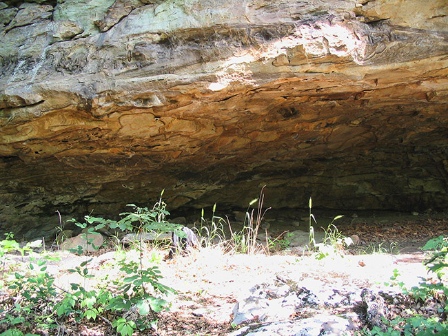 Open space under rock wall