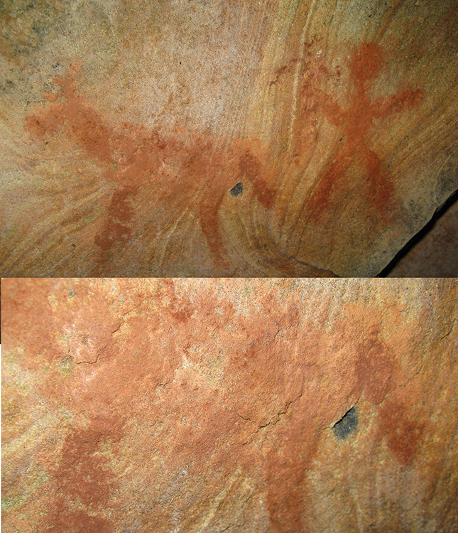 Faded red painting of an animal and a human on rock wall