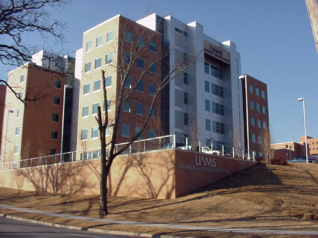 multistory brick steel and glass building labeled "UAMS Biomedical Research Center"