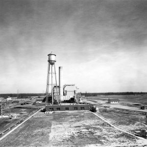 Panorama featuring buildings, smokestack, and water tower