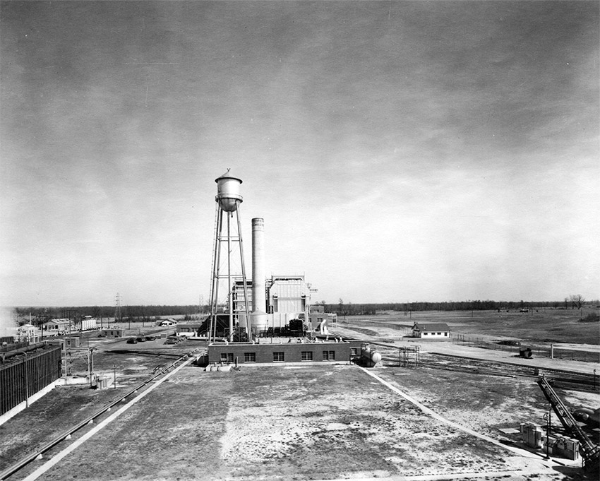 Panorama featuring buildings, smokestack, and water tower