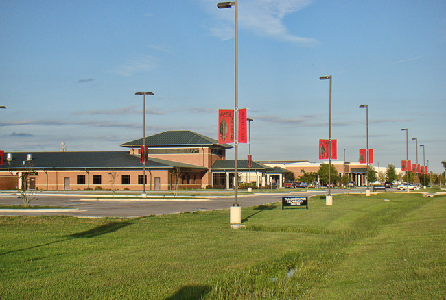 mostly Single-story brick buildings with green roofs and parking lot