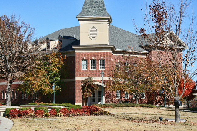 Two-story brick building with tower and grounds