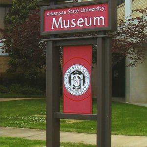 tall sign "Arkansas State University Museum" in front of building