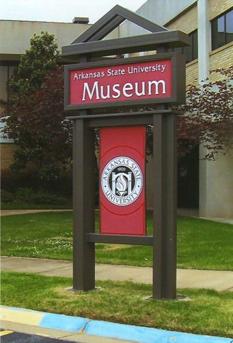 tall sign "Arkansas State University Museum" in front of building