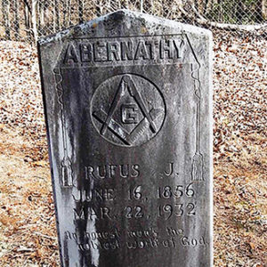 Weathered "Abernathy" gravestone with Masonic symbol and engraving in cemetery