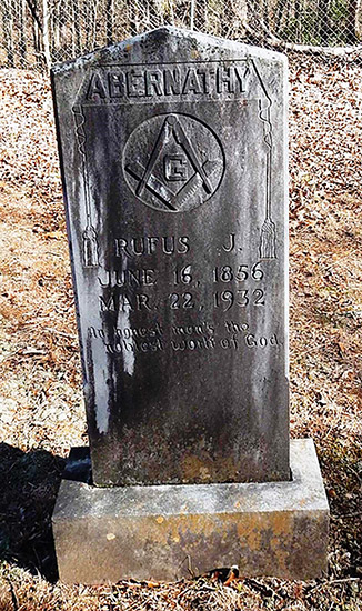 Weathered "Abernathy" gravestone with Masonic symbol and engraving in cemetery
