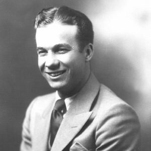 Young white man smiling in suit and tie smiling