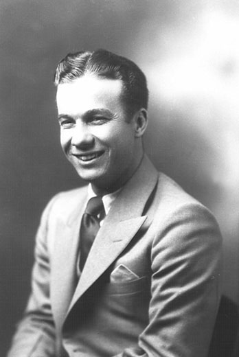Young white man smiling in suit and tie smiling