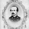 photo portrait with oval border of balding white man with mustache in military uniform
