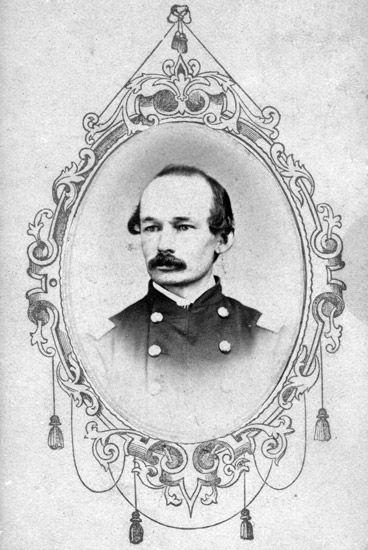 photo portrait with oval border of balding white man with mustache in military uniform