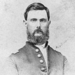 White man with beard standing in military uniform