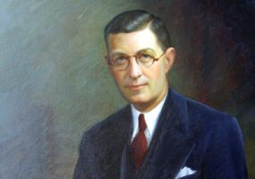 White man wearing glasses in suit and tie