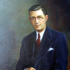 White man wearing glasses in suit and tie