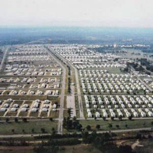 aerial view of military base with many uniformly shaped white buildings in rows