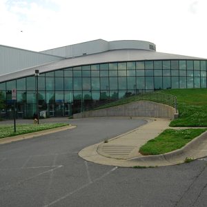 Round building with glass wall and parking lot
