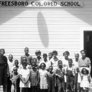 Class of African-American students and teachers with school building "Murfreesboro Colored School"
