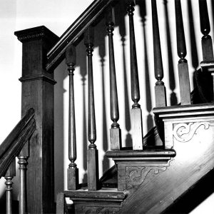Close-up of wooden staircase with hand railing
