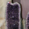 Halved rocks displaying interiors of purple crystal