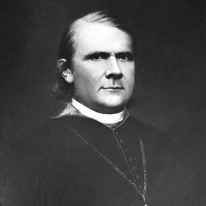 White man in bishop's robes wearing a cross necklace