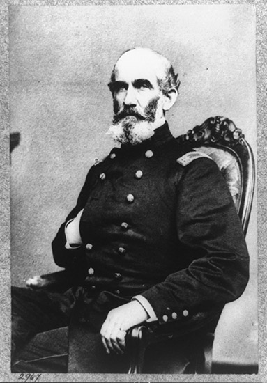 White man with beard in military uniform sitting in a chair