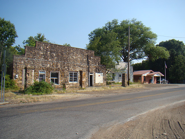 Storefront on street with stone building connected to brick building