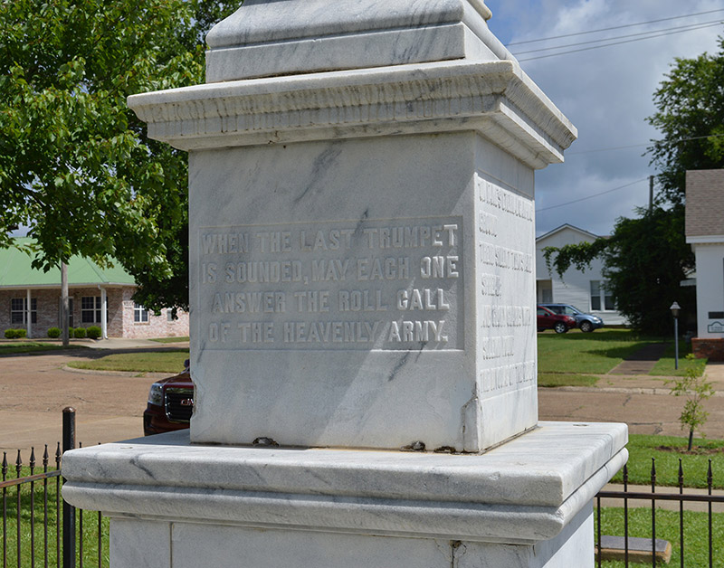 stone pedestal with raised text saying "When the last trumpet is sounded may each one answer the roll call of the heavenly army"