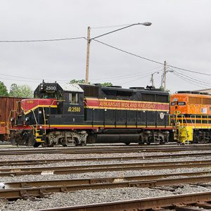 Diesel train and cars in rail yard