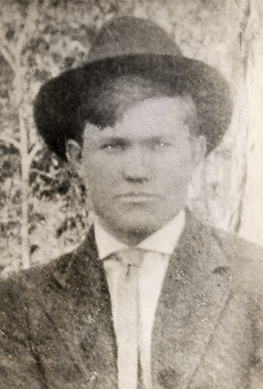 Young white man in hat and suit