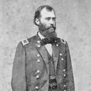 white man with beard in military regalia poses standing