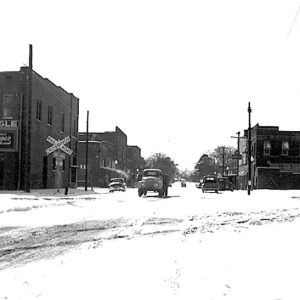 Street scene with brick buildings and railroad crossing