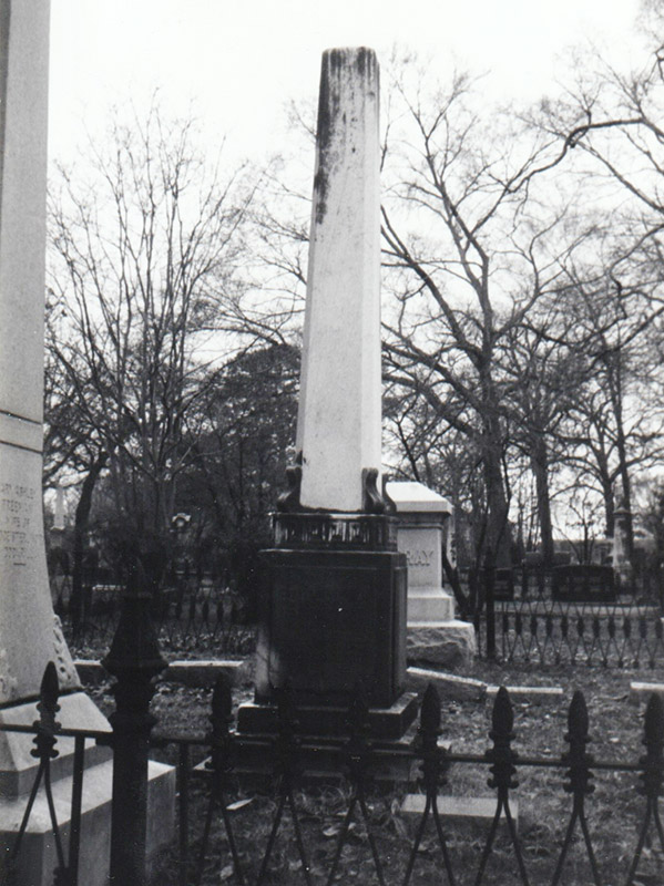 Grave marker standing among others in cemetery