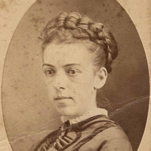 Young white woman with braided hair in collared dress