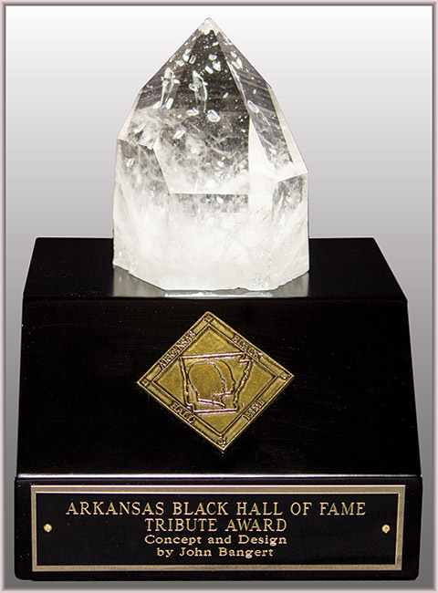 Large pointed crystal on black display base with diamond shaped gold badge and engraved name plate