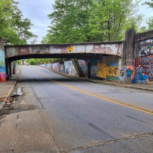 Painted walls under bridge over two-lane road