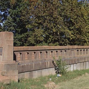 Concrete bridge railing and monument with plaque on it