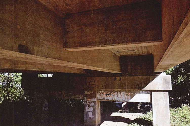 View underneath concrete bridge platform of supporting structures