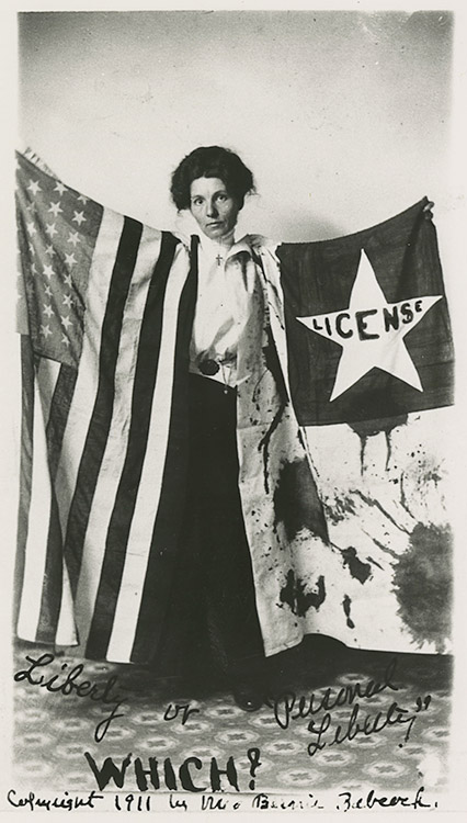 Young white woman standing with flags
