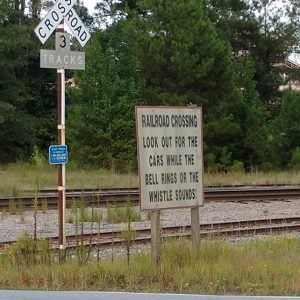 Railroad crossing signs next to train tracks