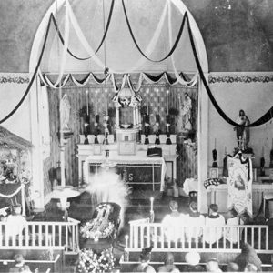 Interior of church with decorations and flowers on casket