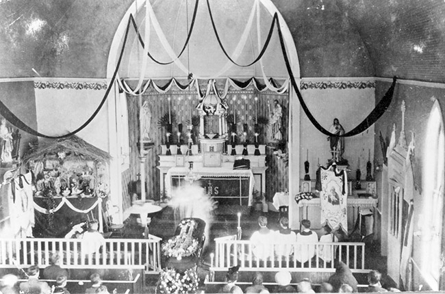 Interior of church with decorations and flowers on casket