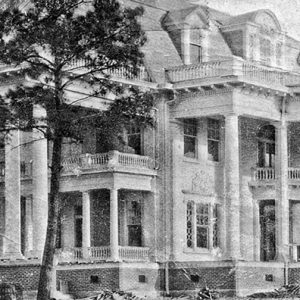 Three-story house with covered porch and balconies with columns