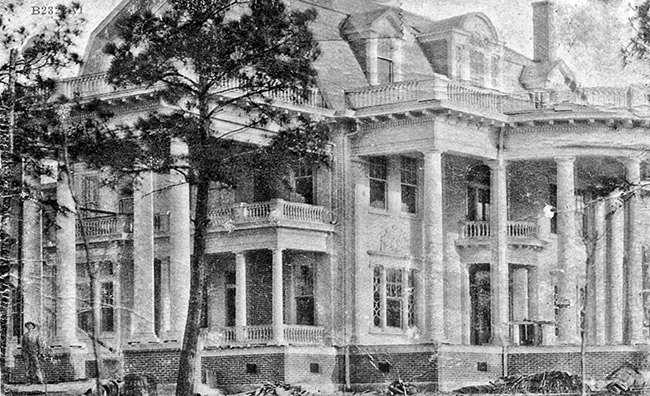 Three-story house with covered porch and balconies with columns