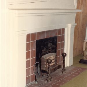 Indoor fireplace with red tiles and gas heater