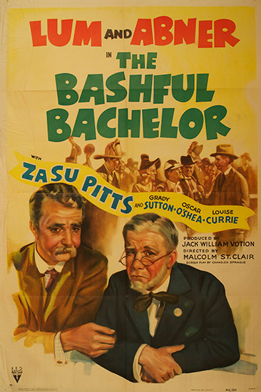 Red black green and blue text on poster with two old white men